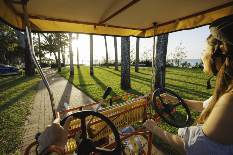 Hire a fun surrey bike from Aquavue! Photo: Tourism QLD